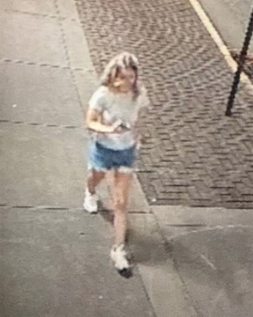 Surveillance image of Eliotte Heinz walking down a sidewalk.